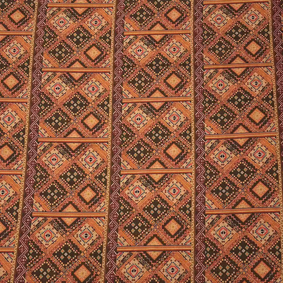 a repeating pattern of a geometric design with a mix of orange, black, and brown colors. The pattern consists of various shapes and lines, creating a visually striking and intricate design.