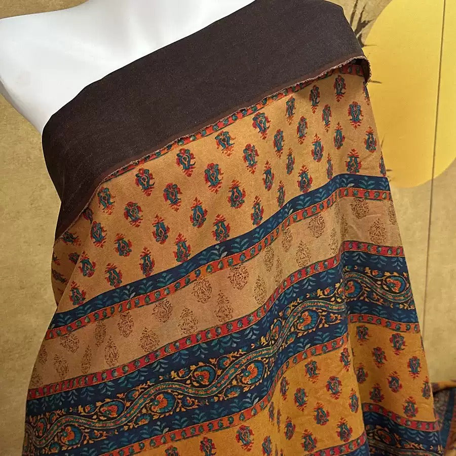a mannequin wearing a colorful, patterned fabric draped over its body.