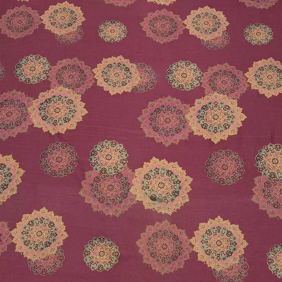 a repeating pattern of colorful, intricate floral designs on a dark red background.