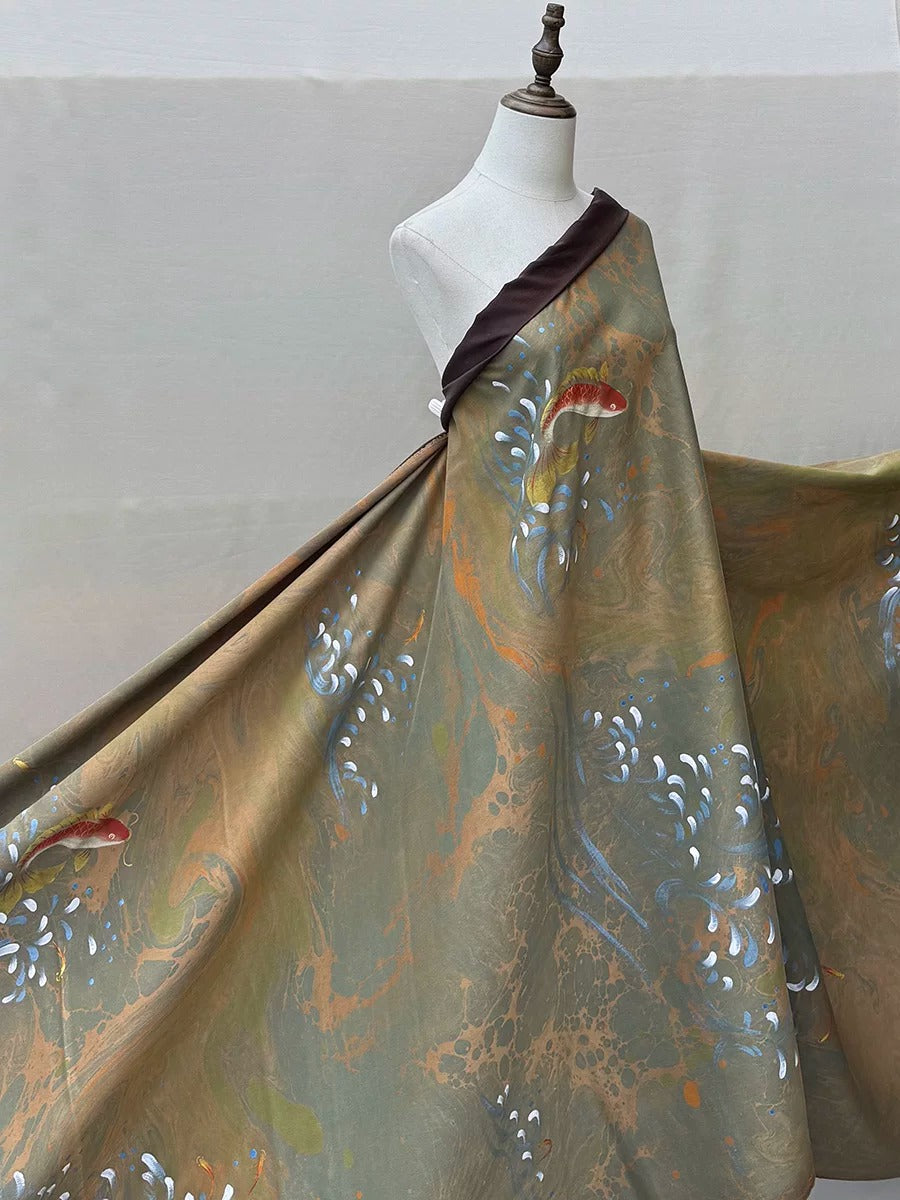 A mannequin wearing a flowing, patterned dress with a dark brown collar.
