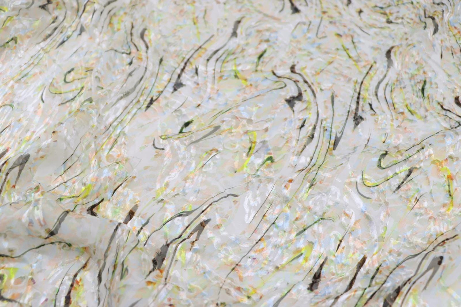 The image is a close-up of a textured surface with a pattern of black and white lines and swirls, creating a visually striking and abstract design.