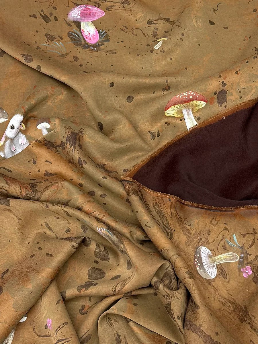 The image is a close-up of a fabric with a brown and beige color scheme, featuring various mushrooms and other organic shapes.
