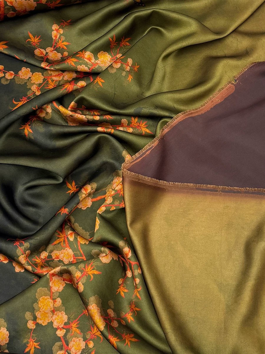 The image is a close-up of a fabric with a floral pattern, featuring a mix of green and brown colors. The fabric appears to be made of silk or a similar material, with a crinkled texture. The floral pattern consists of orange and yellow flowers, creating a vibrant and visually appealing design.