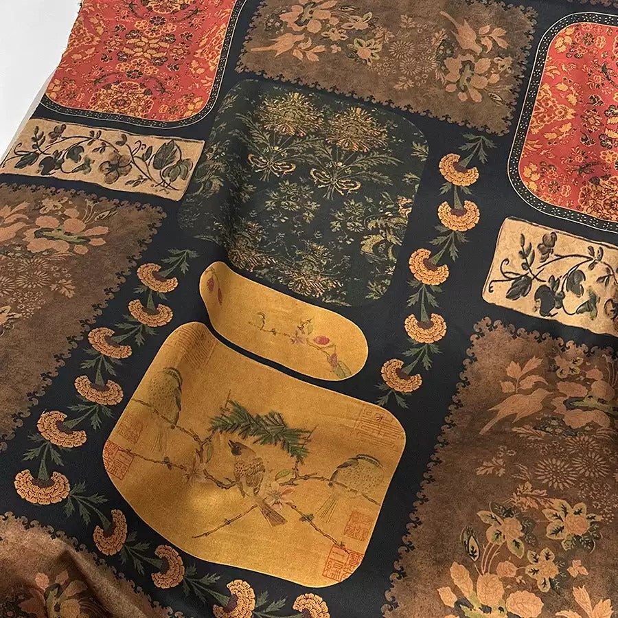 The image is a close-up of a fabric with a variety of colorful and intricate patterns, including floral designs, birds, and other decorative elements.