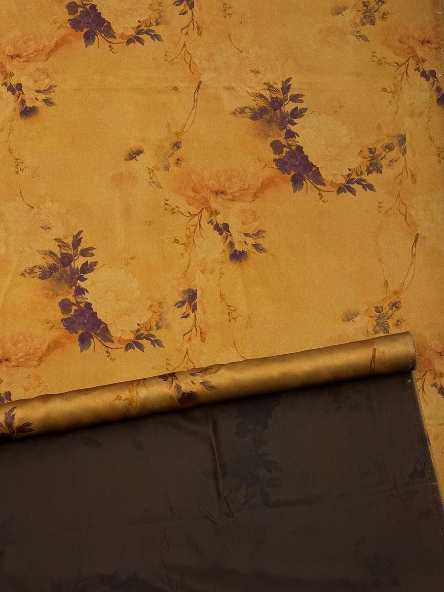 a floral pattern on a yellow background, with a dark fabric or material placed on top of it.