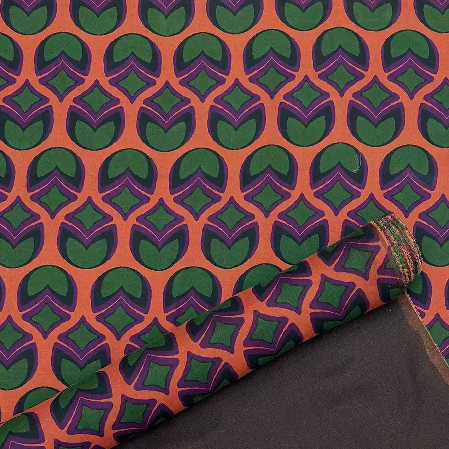 a repeating pattern of green and orange circles on a dark background.