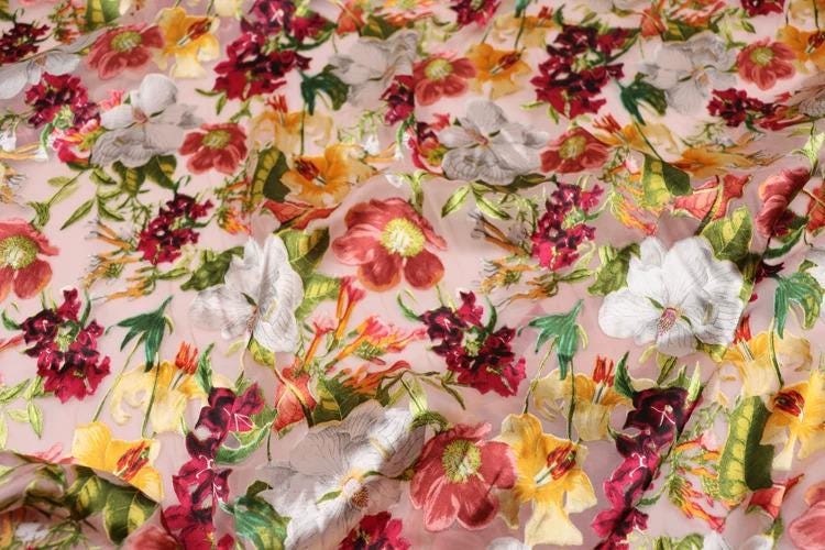 The image is a close-up view of a fabric with a vibrant floral pattern. The fabric is adorned with a variety of colorful flowers, including red, white, yellow, and green, creating a visually striking and lively design. The flowers are arranged in a way that fills the entire fabric, showcasing the intricate details and textures of the floral patterns.
