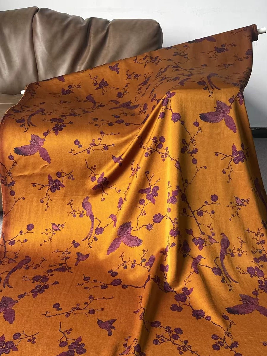 a vibrant, floral-patterned fabric with a mix of orange and purple colors, creating a visually striking and eye-catching design.