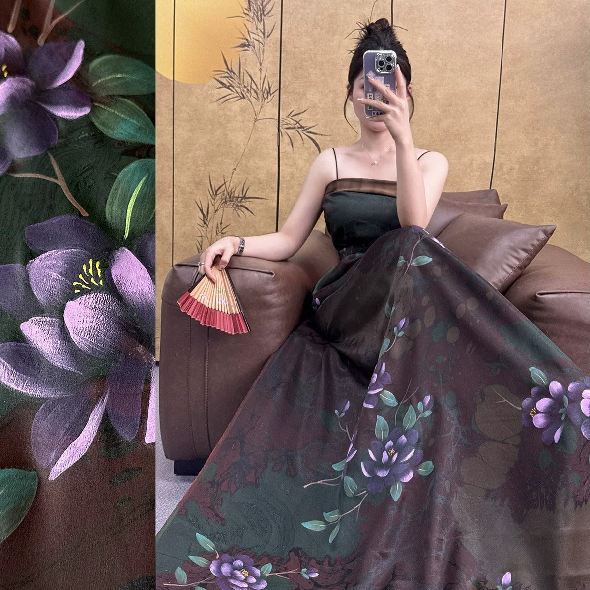 A woman in a long, floral-patterned dress is sitting on a couch, holding a fan and taking a selfie with her phone.
