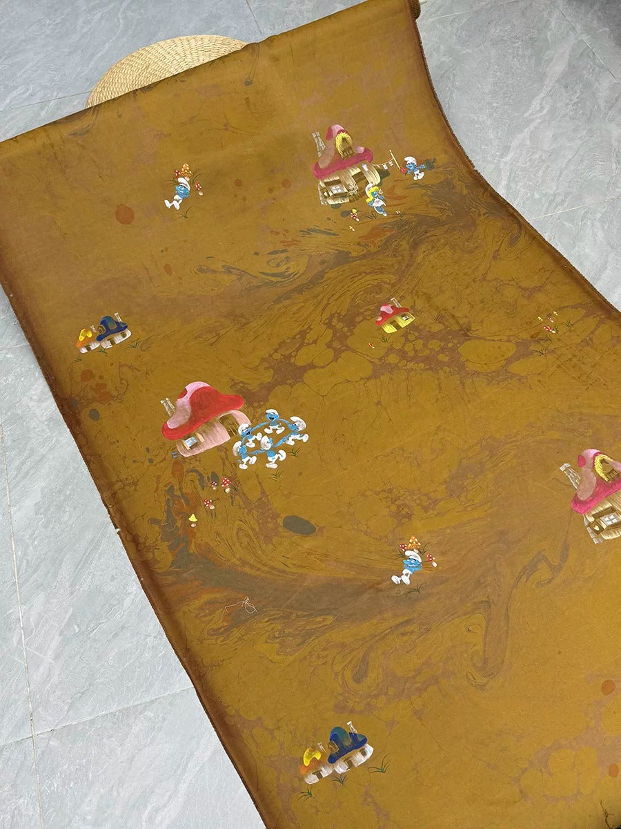 a brown fabric with a marbled pattern, depicting various small figures and objects, such as houses, cars, and people, arranged in a playful and whimsical manner.