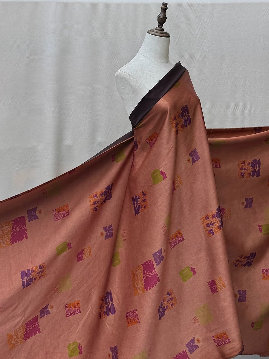 A mannequin wearing a long, flowing dress with a pattern of pink and orange flowers and leaves.