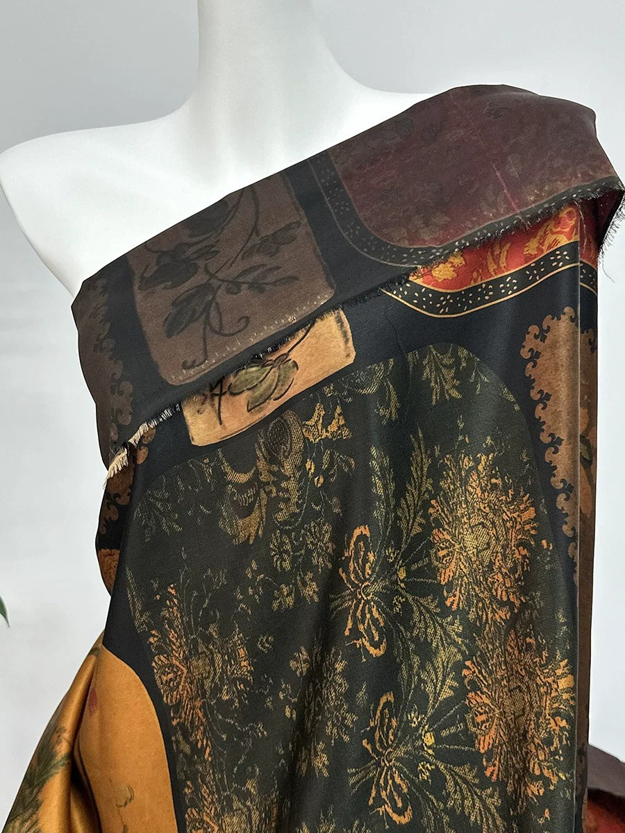 a mannequin wearing a colorful, patterned dress with a mix of black, gold, and red colors.