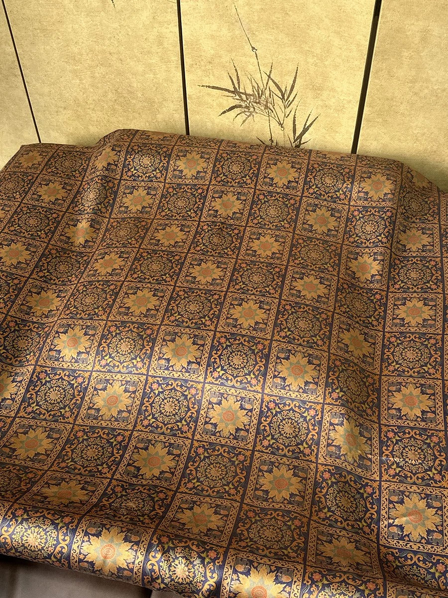 a large, ornate, and intricately patterned fabric with a floral design, placed on a surface.