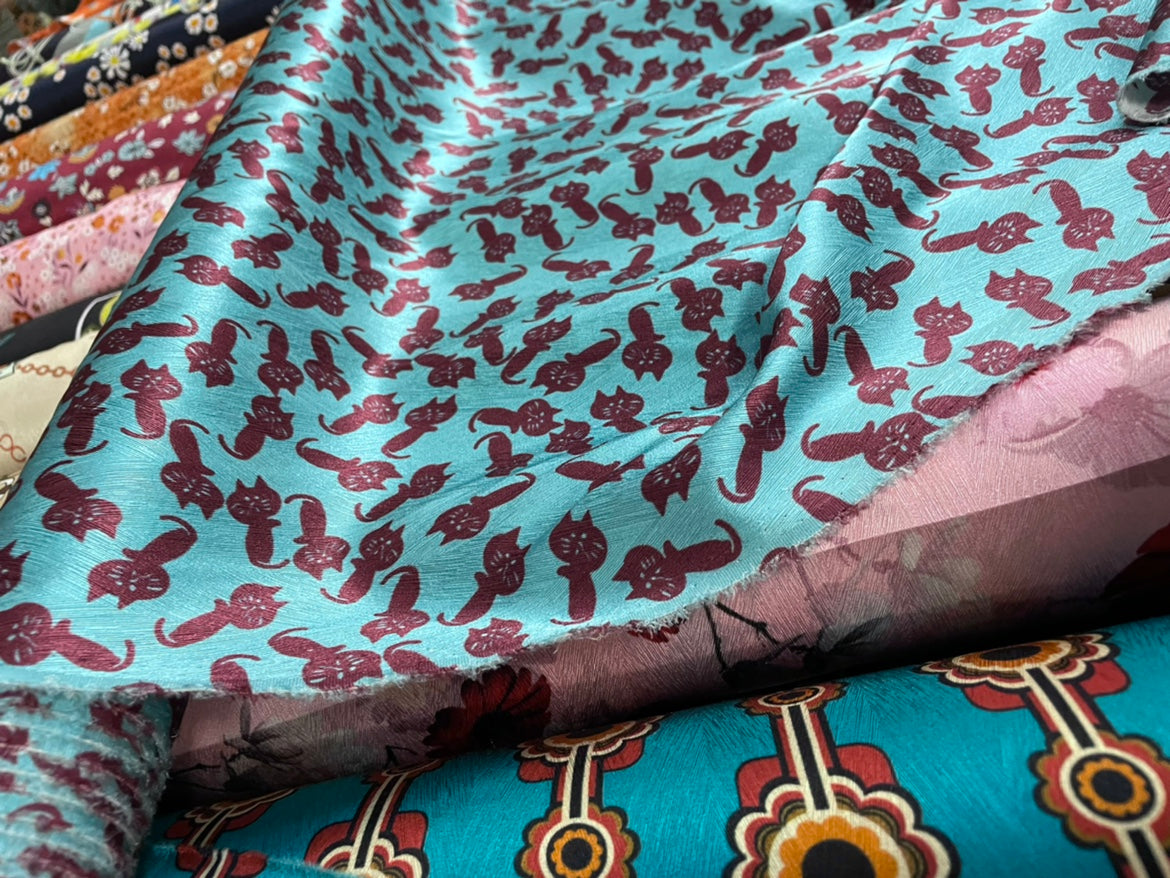 KATMAO - 19 Momme Reddish Brown Cartoon Cat on Blue Background Pattern Digital Print Stretch Silk Satin Fabric - 108cm wide by the Yard