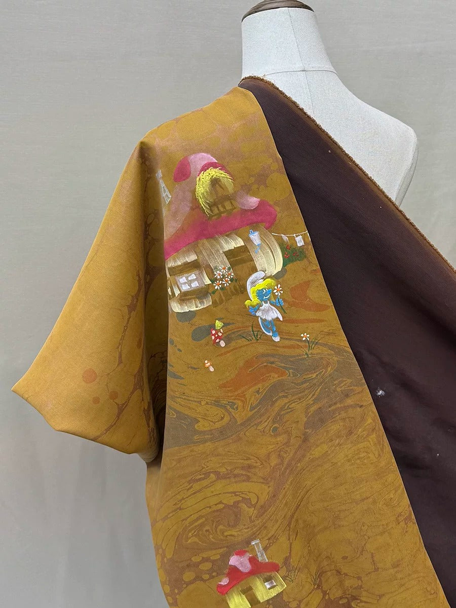 a mannequin wearing a colorful, patterned fabric with a whimsical design depicting a house and a character.
