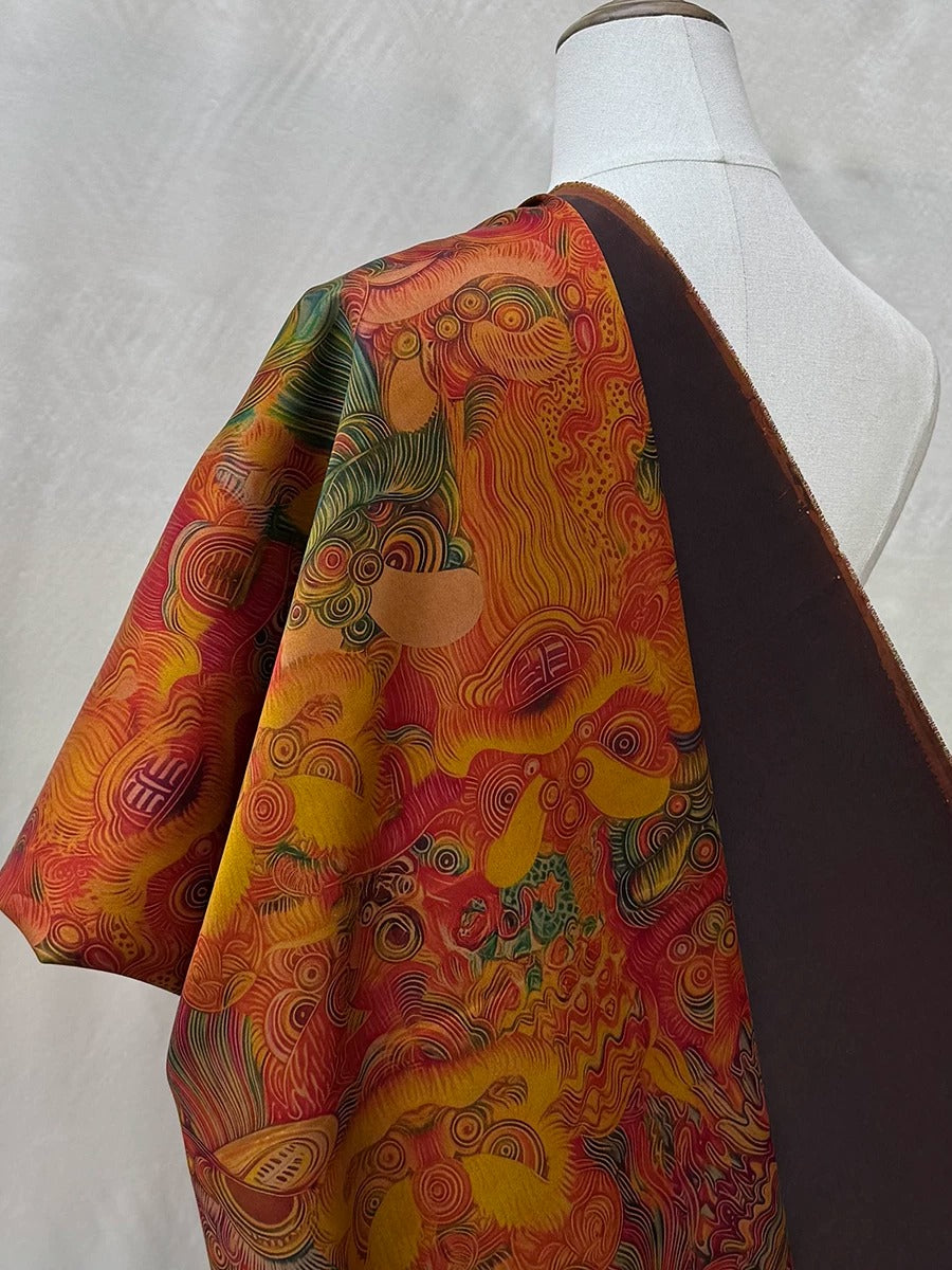 a mannequin wearing a colorful, patterned fabric draped over its shoulder.
