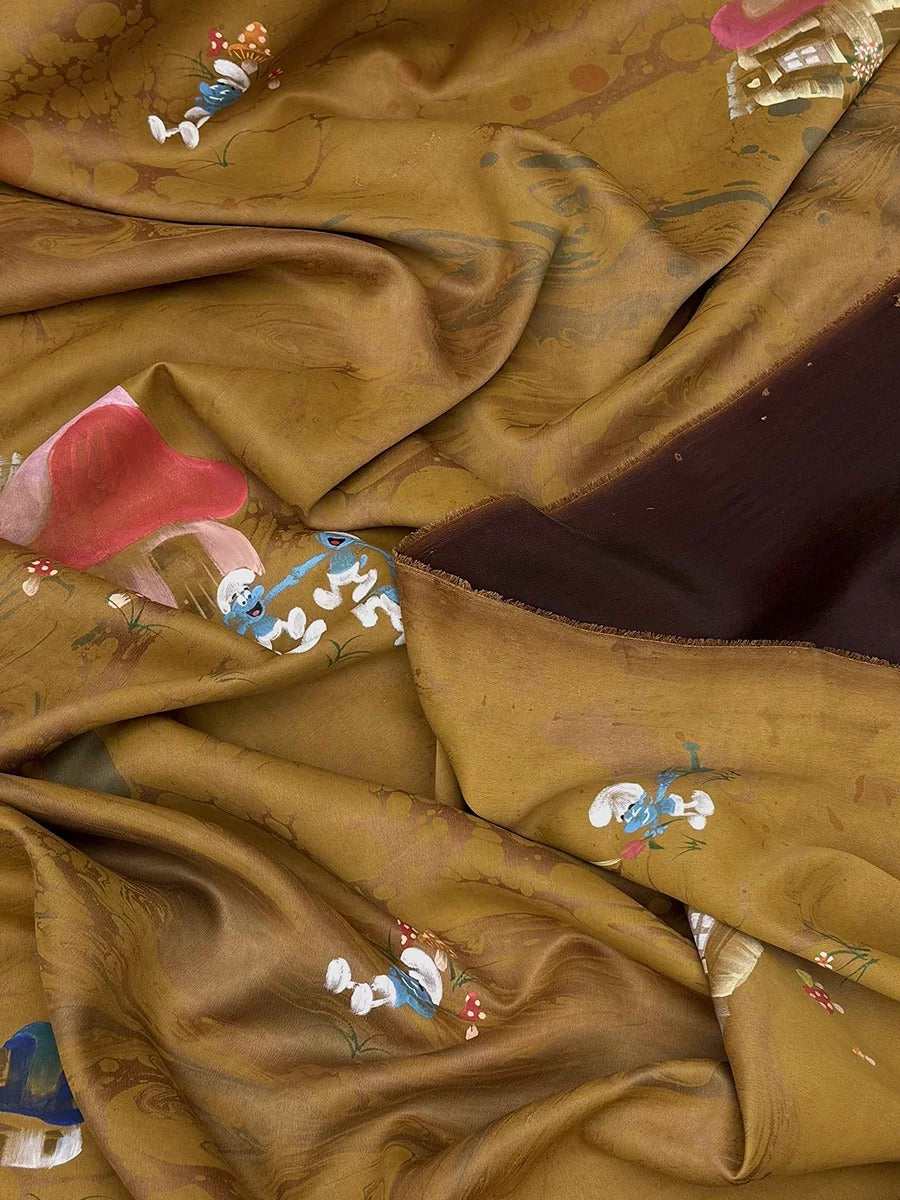 The image is a close-up of a fabric with a brown and gold color scheme, featuring various cartoon-like characters and designs.