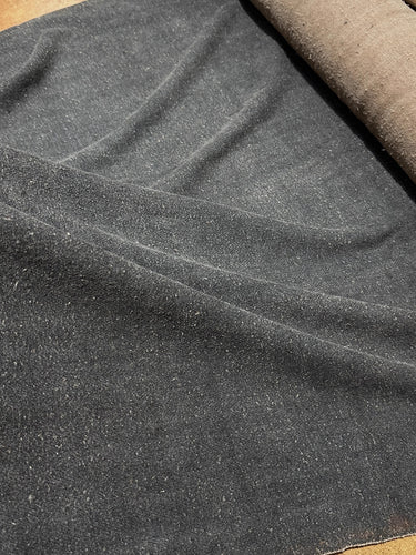 a close up of a piece of cloth on a table#color_black-brown