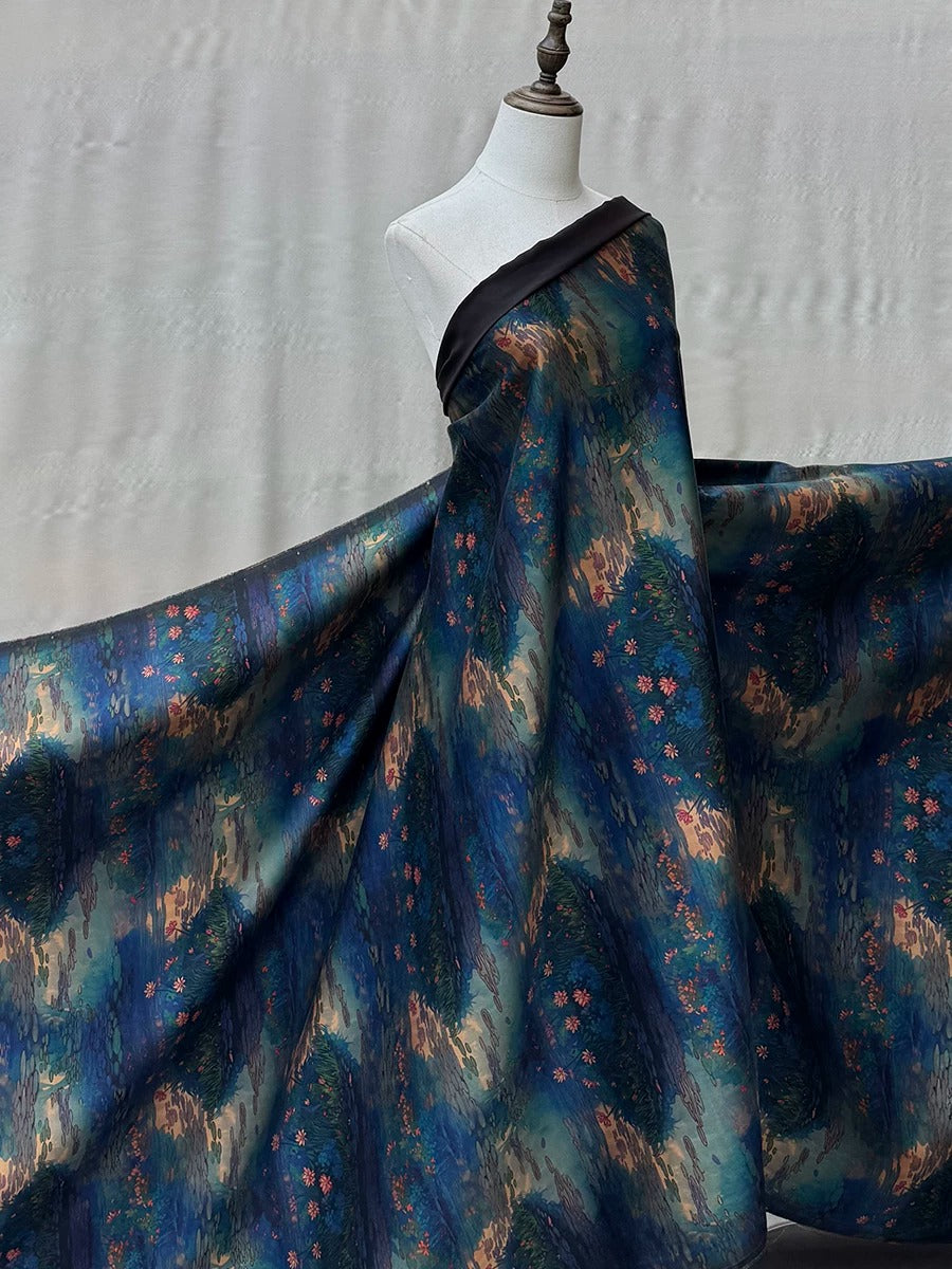 A mannequin wearing a long, flowing dress with a vibrant, abstract pattern in shades of blue, green, and orange.