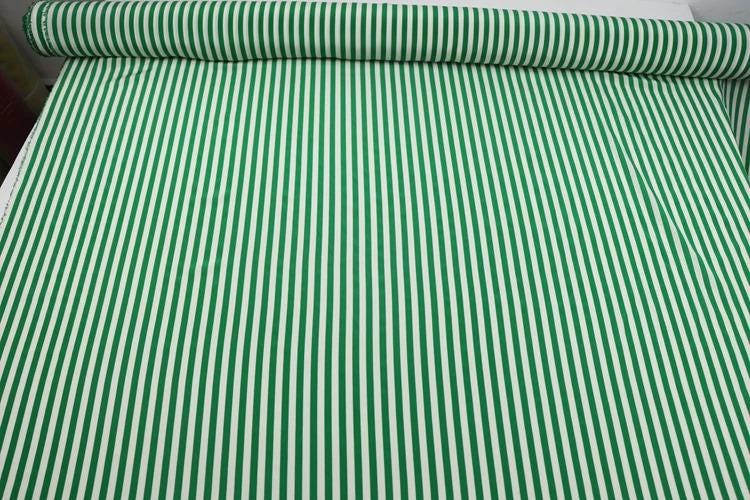 a roll of green and white striped fabric.