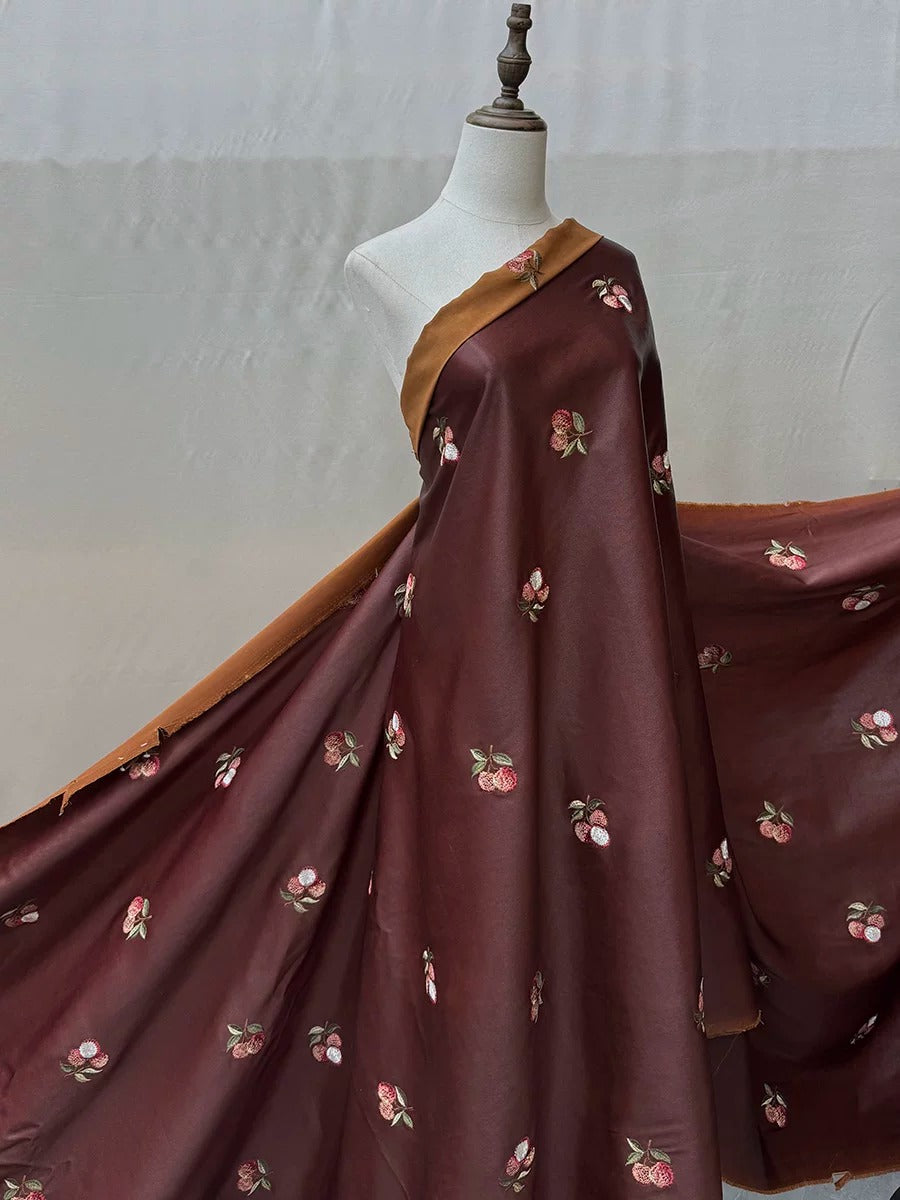 A mannequin wearing a burgundy dress with a floral pattern, displayed against a plain background.
