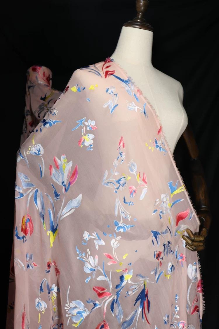 A mannequin wearing a pink floral print dress with a white bodice.