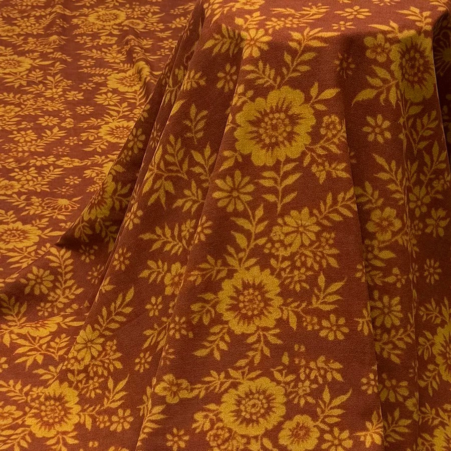 a close up of a table cloth with flowers on it