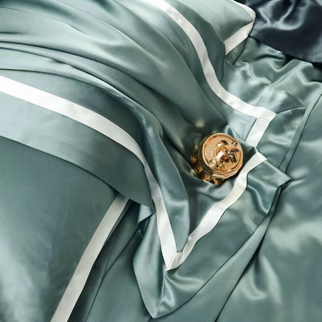 a close up of a green satin with a gold button