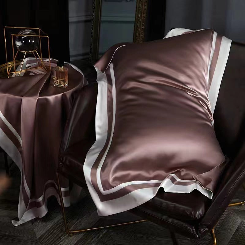 a chair with a pillow and a blanket on it