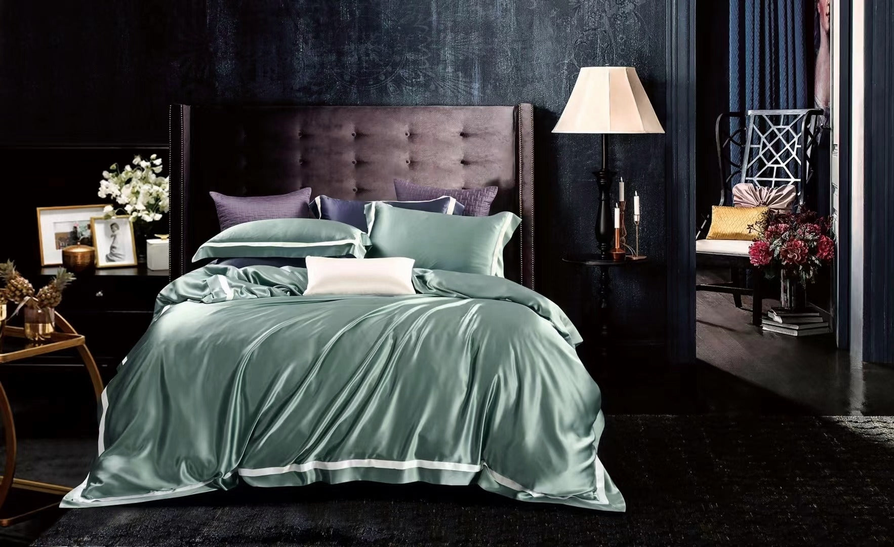 a bed with a green comforter and pillows
