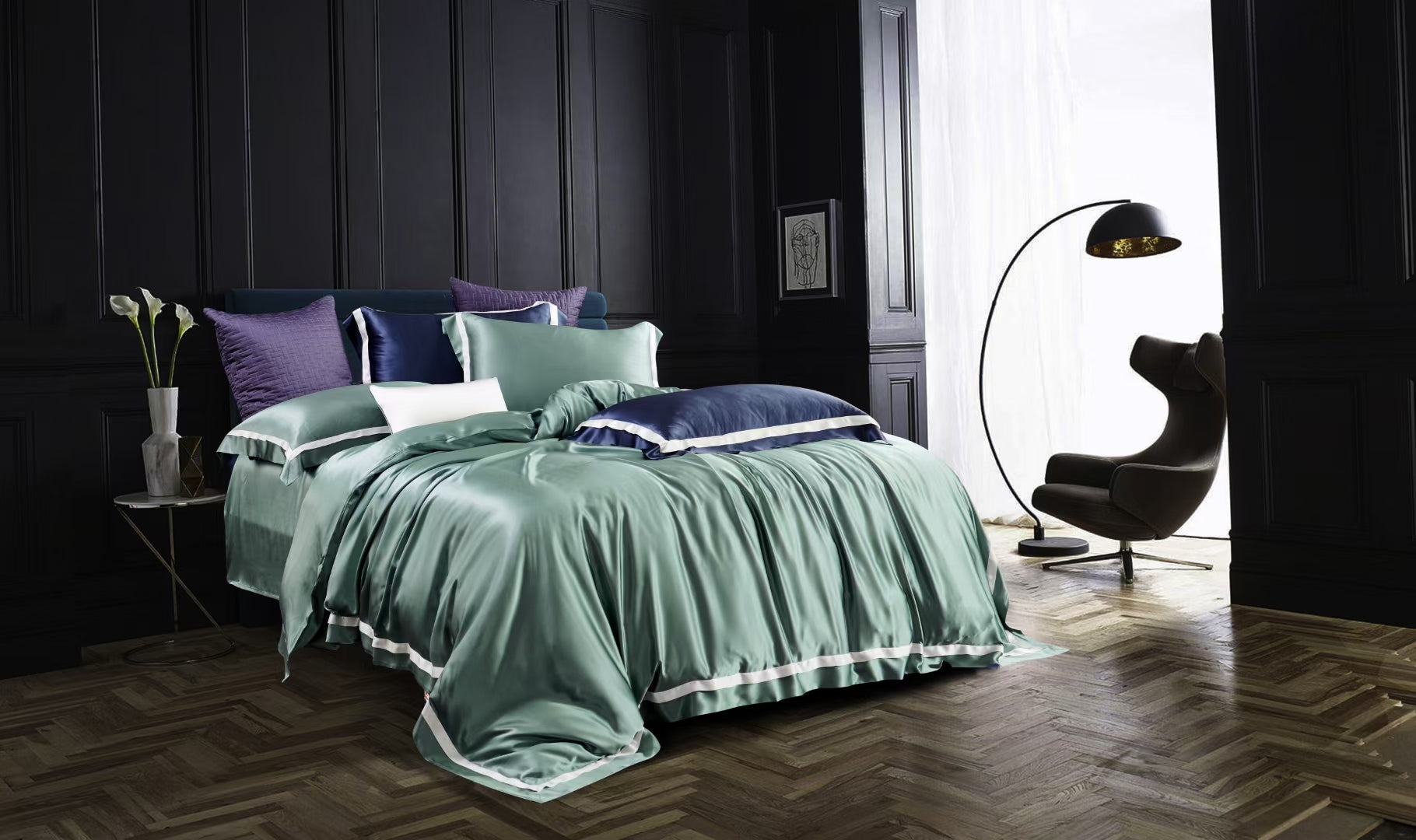 a bed with a green comforter and pillows