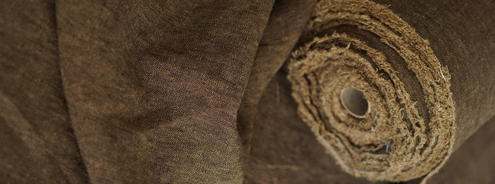 Close-up of rolled brown plant fiber fabric with a natural textured weave
