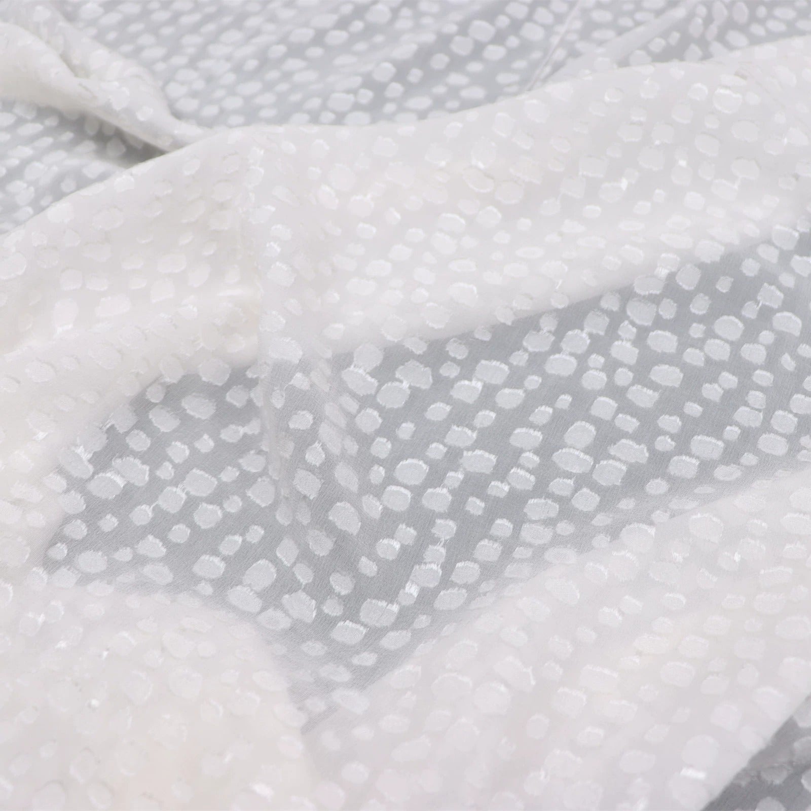 a close-up view of a fabric with a white polka dot pattern.