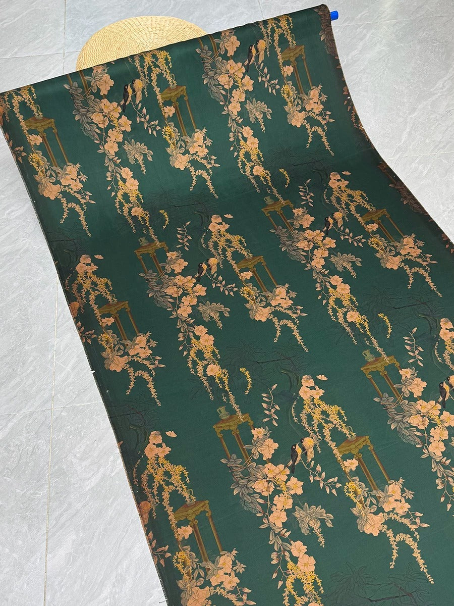 a roll of wallpaper with a floral pattern in shades of green and gold.