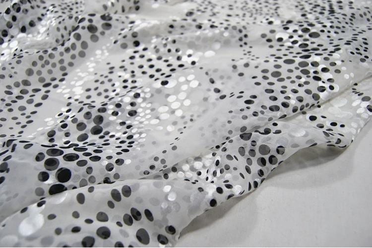 a close-up view of a fabric with a black and white polka dot pattern.