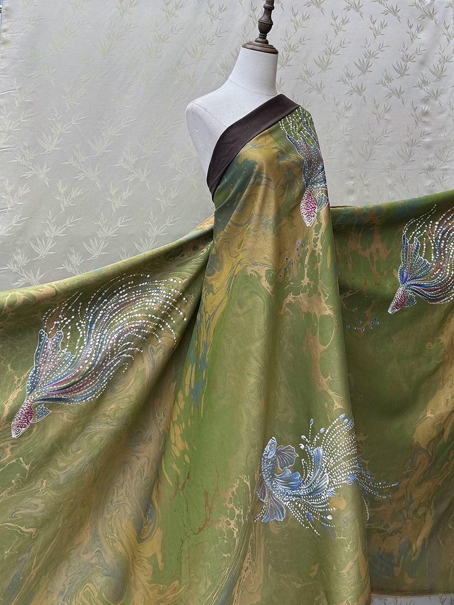A mannequin wearing a vibrant, flowing green dress with intricate floral patterns and designs.