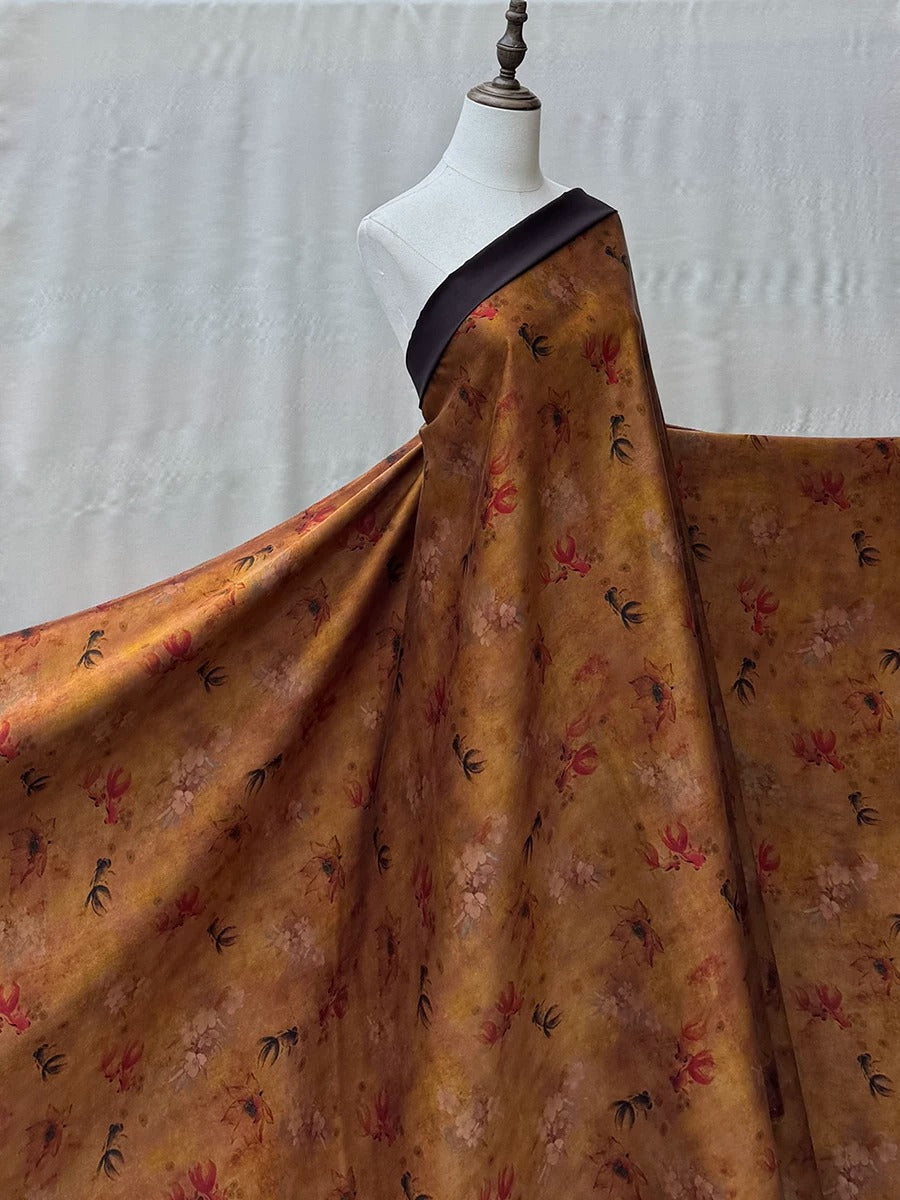 A mannequin wearing a large, flowing dress with a floral print in shades of brown and orange.