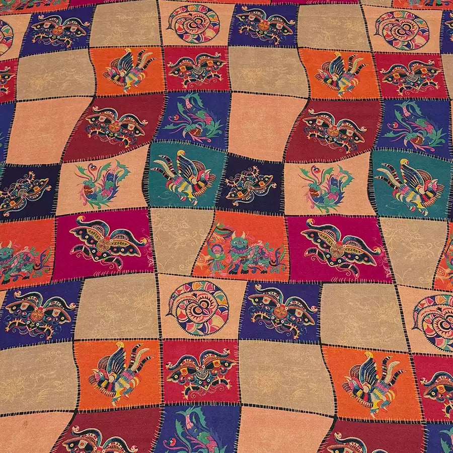 a multicolored patchwork quilt with a decorative design