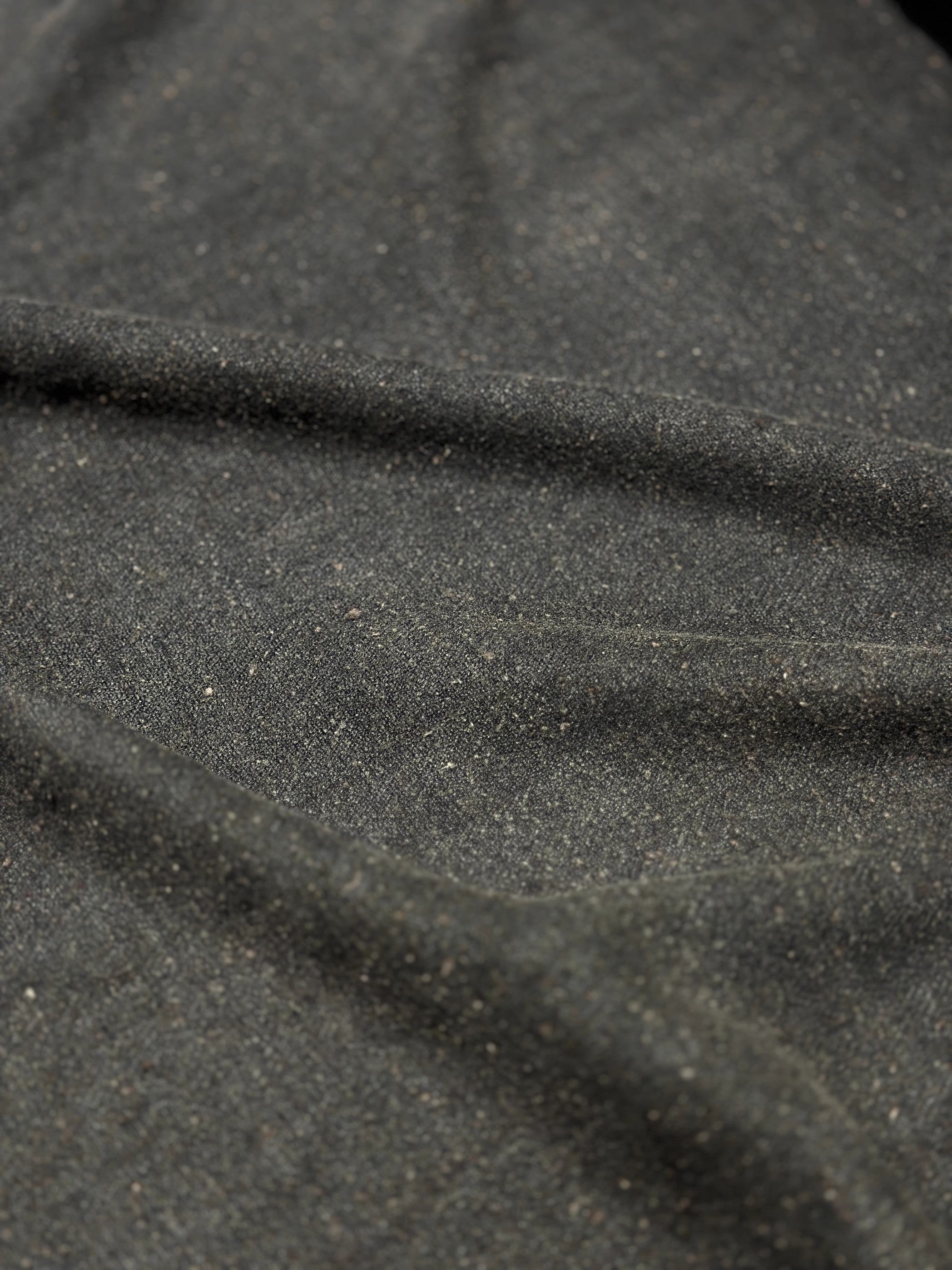 a close up of a piece of mud tussah silk #color_black-brown