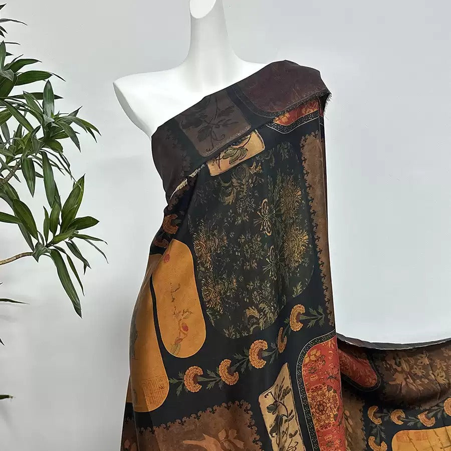 A mannequin wearing a colorful, patterned dress with a brown and black color scheme.