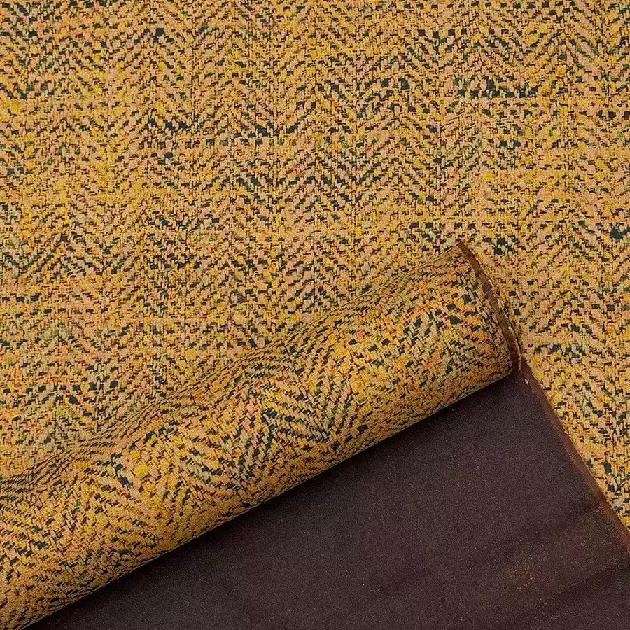 a close-up view of a fabric with a herringbone pattern, featuring a mix of yellow and black colors. The fabric appears to be a type of woven textile, possibly a rug or a textile product.