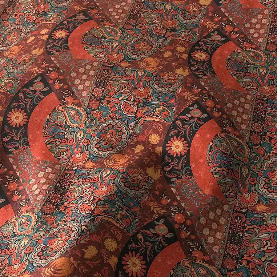 a vibrant and intricate pattern of red, orange, and black floral designs, creating a visually striking and detailed textile.