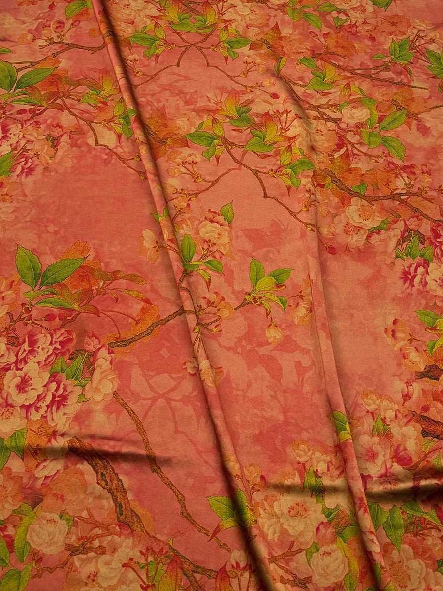 a vibrant floral print with a mix of pink, orange, and green colors, creating a visually striking and lively pattern.