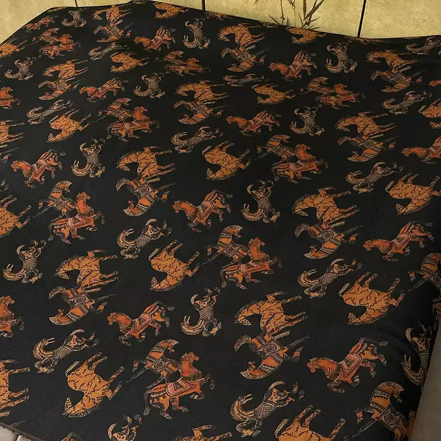 a black and orange patterned fabric with a repeating design of various animals, including horses, cows, and zebras, arranged in a visually striking and intricate manner.