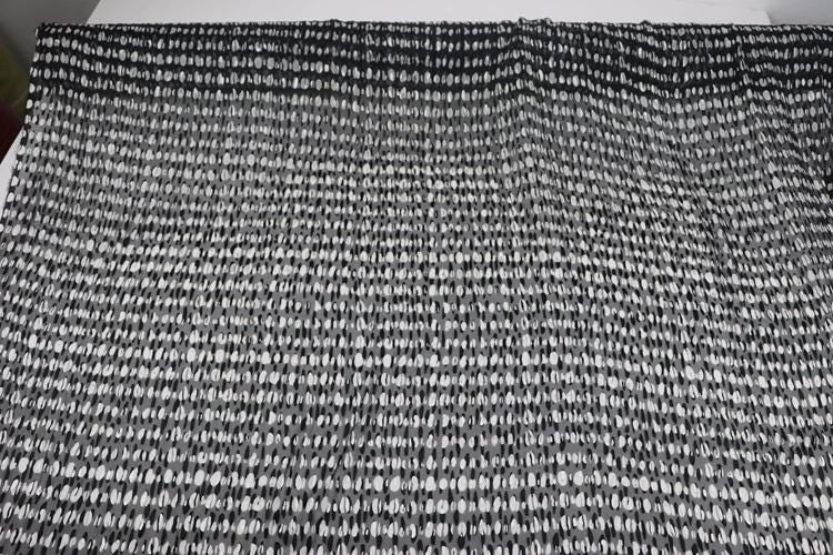 a close-up view of a fabric with a black and white checkered pattern.