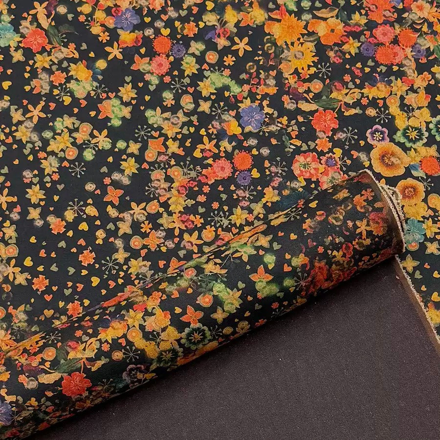 a close-up view of a vibrant, colorful floral pattern on a dark background.