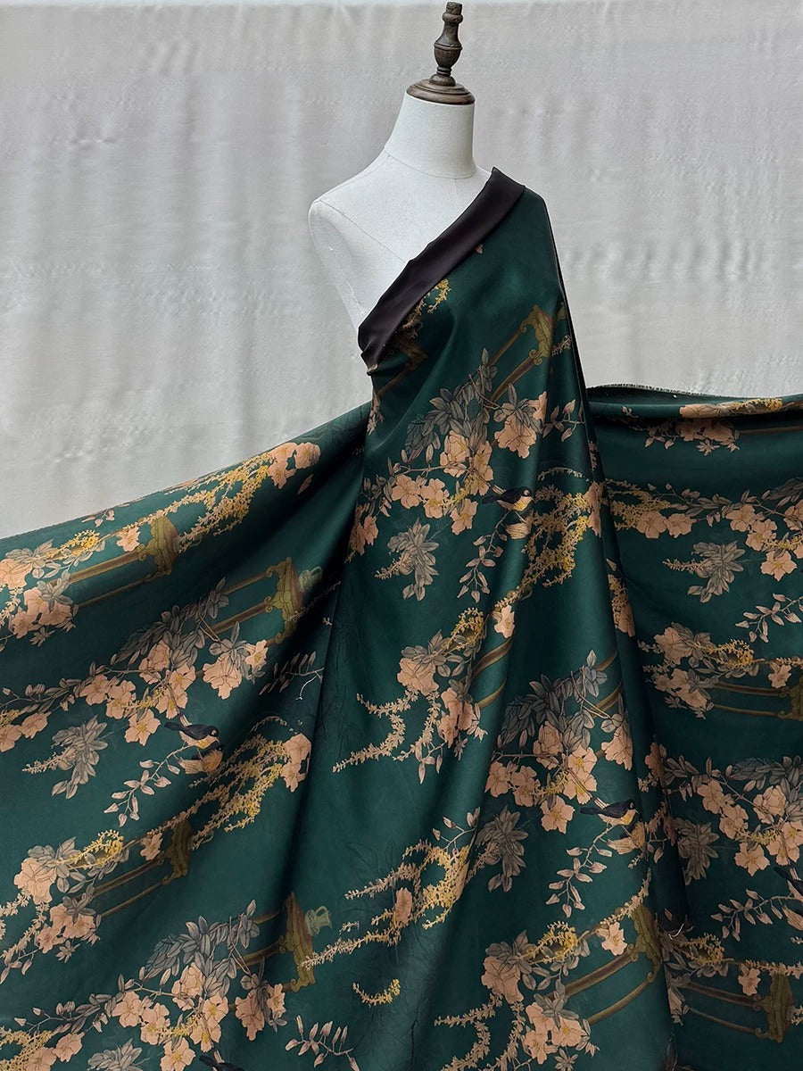 A mannequin wearing a green dress with a floral pattern.
