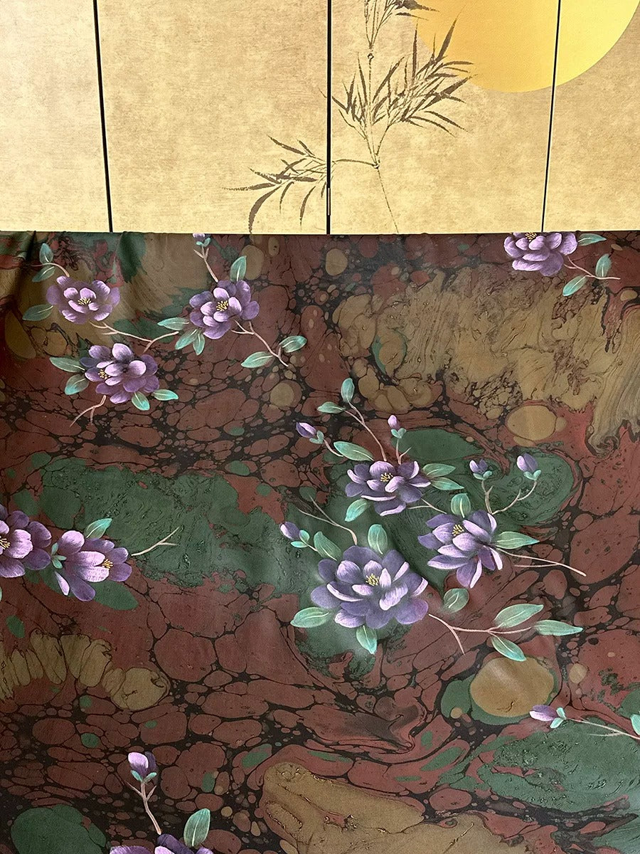 a vibrant floral pattern with purple flowers and green leaves against a brown and green background.