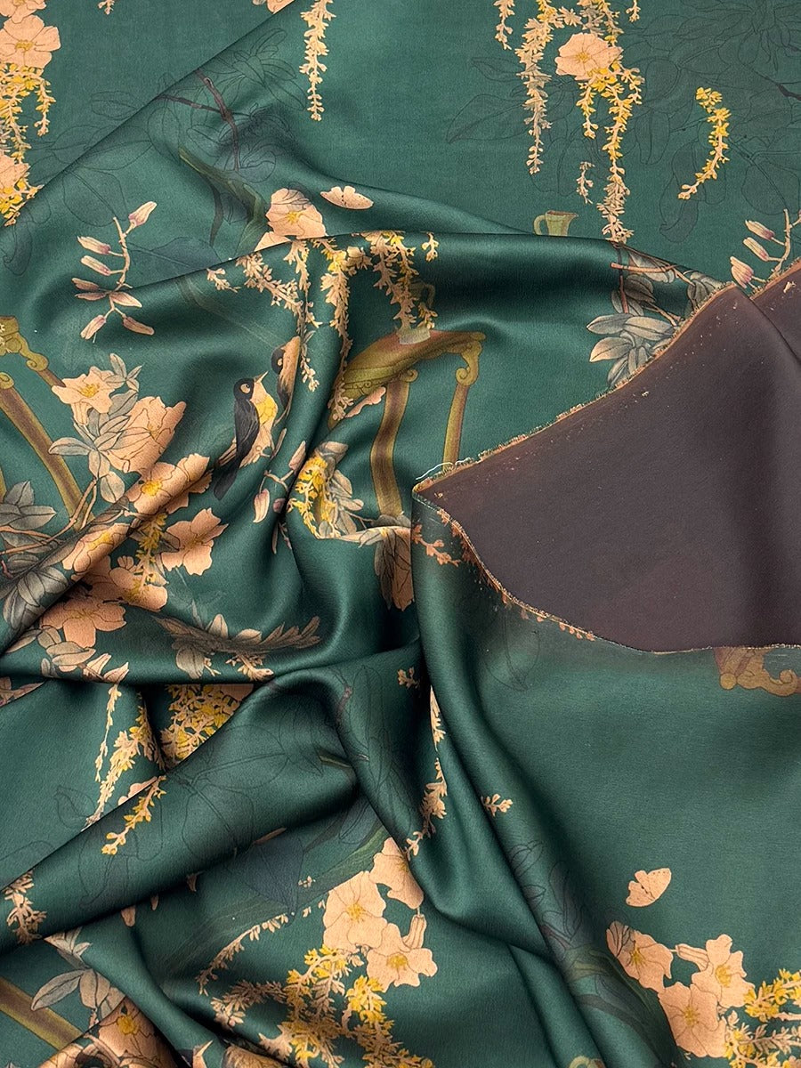 a close-up view of a fabric with a floral pattern in shades of green and gold. The fabric appears to be crumpled and wrinkled, giving it a textured and organic appearance.