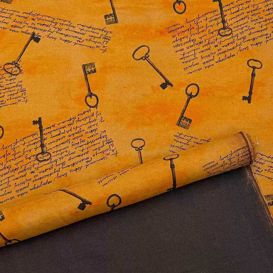 a close-up view of a roll of paper with a repeating pattern of black keys on an orange background.